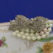 A close up of the pearls and bow button...just the right amount of bling. A close up of the pearls and bow button...just the right amount of bling.